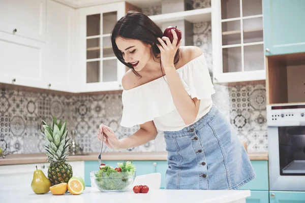 Beautiful woman with healthy food fruit in the kitchen