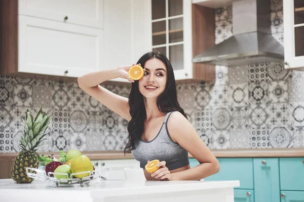 Beautiful woman with healthy food fruit in the kitchen