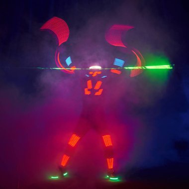 Laser show performance, dancers in led suits with LED lamp, very beautiful night club performance, party.