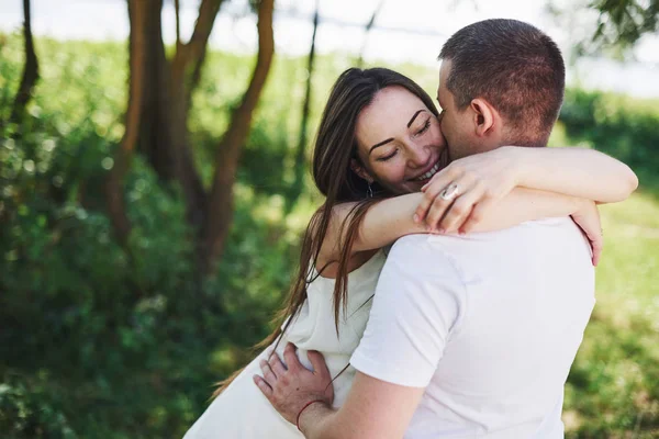 幸せと若い妊娠中のカップルが自然の中で抱擁 ロマンチックな瞬間 — ストック写真