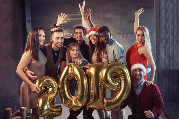 New 2019 Year is coming! Group portrait of Cheerful old friends communicate with each other. The party is devoted to the celebration of the new year. Concepts about youth togetherness lifestyle.