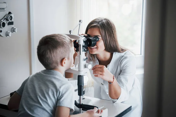 Orvos Mosolyog Kisfiú Akinek Szemére Női Orvos Speciális Optikai Készülékkel — Stock Fotó