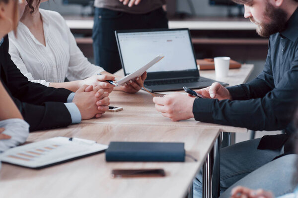 A group of business partners discusses the ideas during an office meeting.
