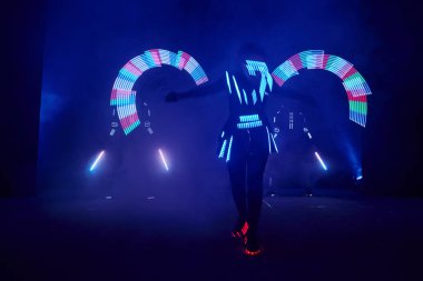 Laser show performance, dancers in led suits with LED lamp, very beautiful night club performance, party.