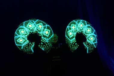 Laser show performance, dancers in led suits with LED lamp, very beautiful night club performance, party.