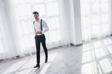 Bir karar vermem gerek. Lüks takım elbiseli bir adam elinde viskiyle beyaz bir odada yürüyor..