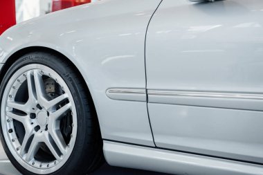 Front part of modern white bright car standing indoors.