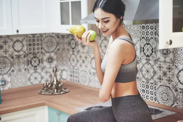 Beautiful woman with healthy food fruit in the kitchen