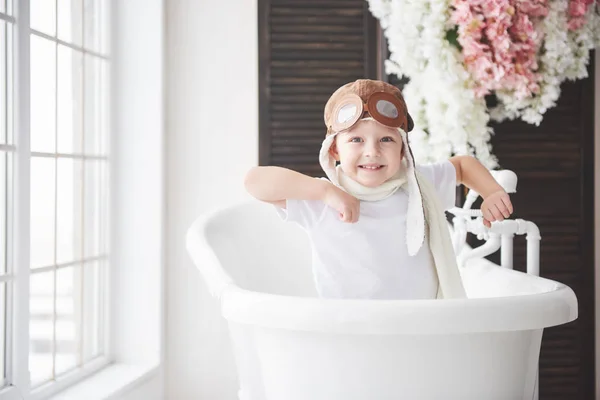 stock image Happy kid in pilot hat playing in bathroom. Childhood. Fantasy, imagination. Holiday