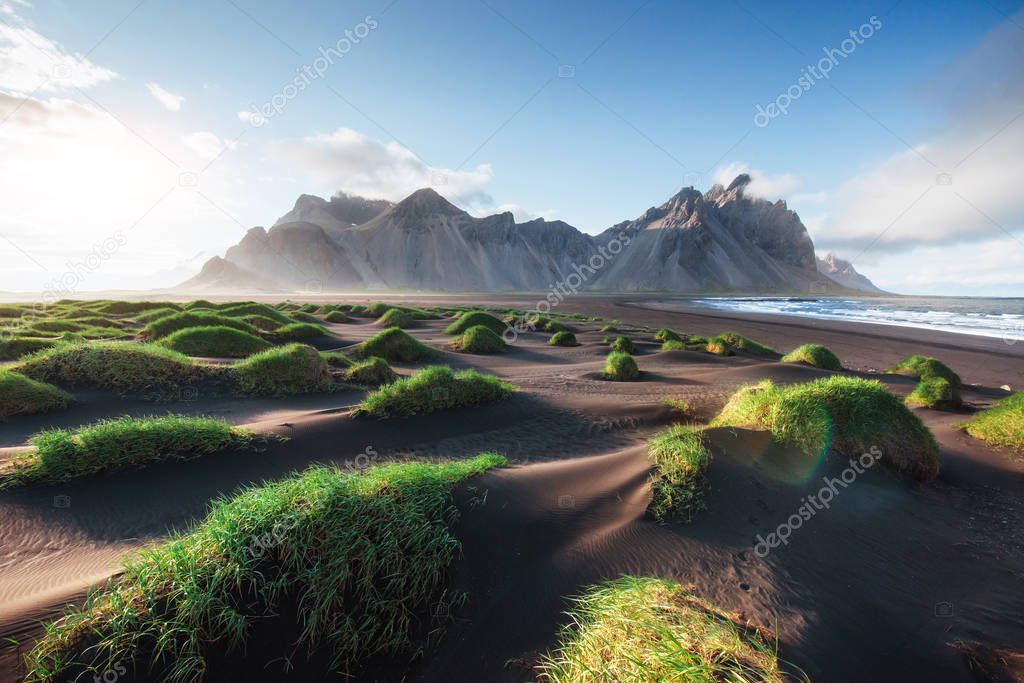 Fantastic west of the mountains and volcanic lava sand dunes on the beach Stokksness, Iceland. Colorful summer morning Iceland, Europe.