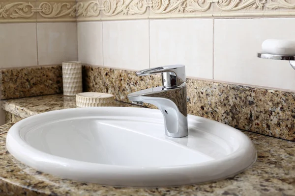 Modern white sink in brown interior — Stock Photo, Image