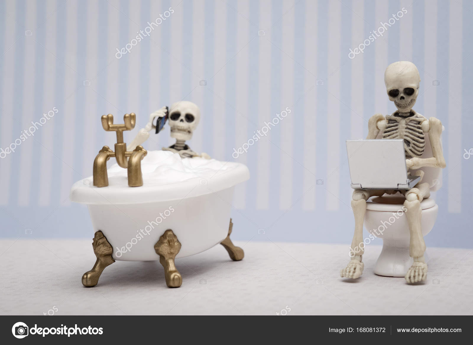 Two Skeletons Chatting And Working In The Bathroom Stock Photo