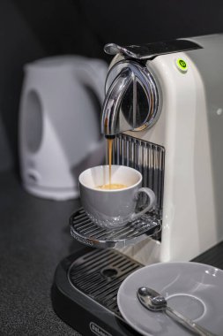 Budapest, Hungary - November 23, 2019: Coffee making process with household DeLonghi nespresso machine.
