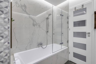 Budapest, Hungary - April 18, 2019: Luxurious white marble bathroom in an Airbnb accommodation, angled view.