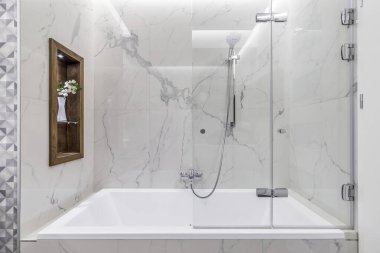 Budapest, Hungary - April 18, 2019: Luxurious white marble bathroom in an Airbnb accommodation, straight view.
