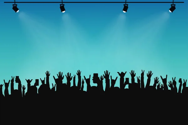 Concert crowd, people silhouettes. Hands with different gestures and smartphones in raised hands. Spotlights on stage