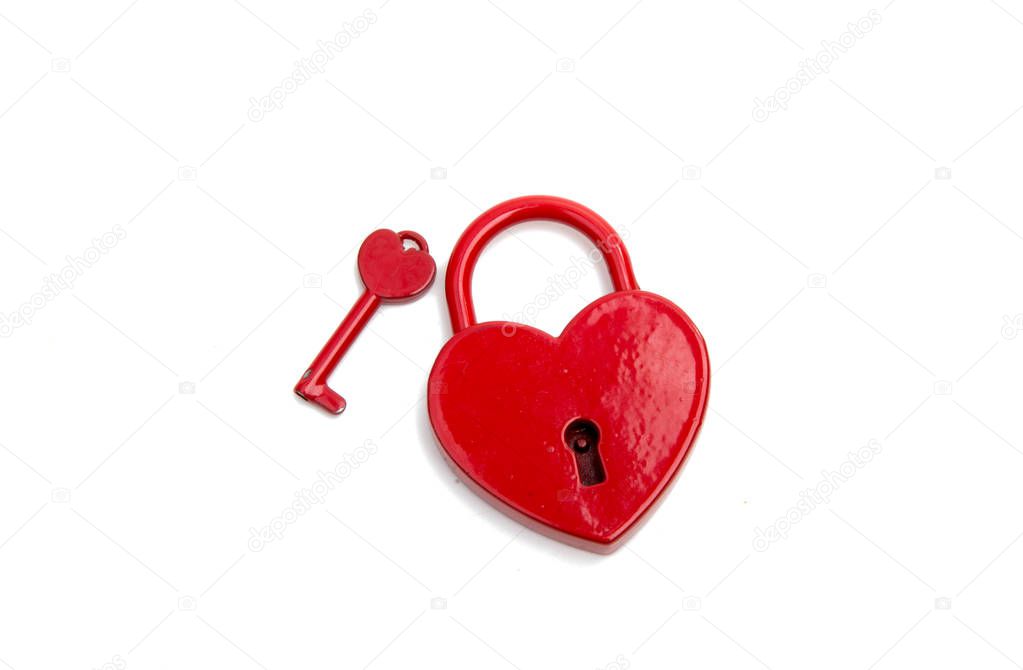 metalic red heart with a key on the white