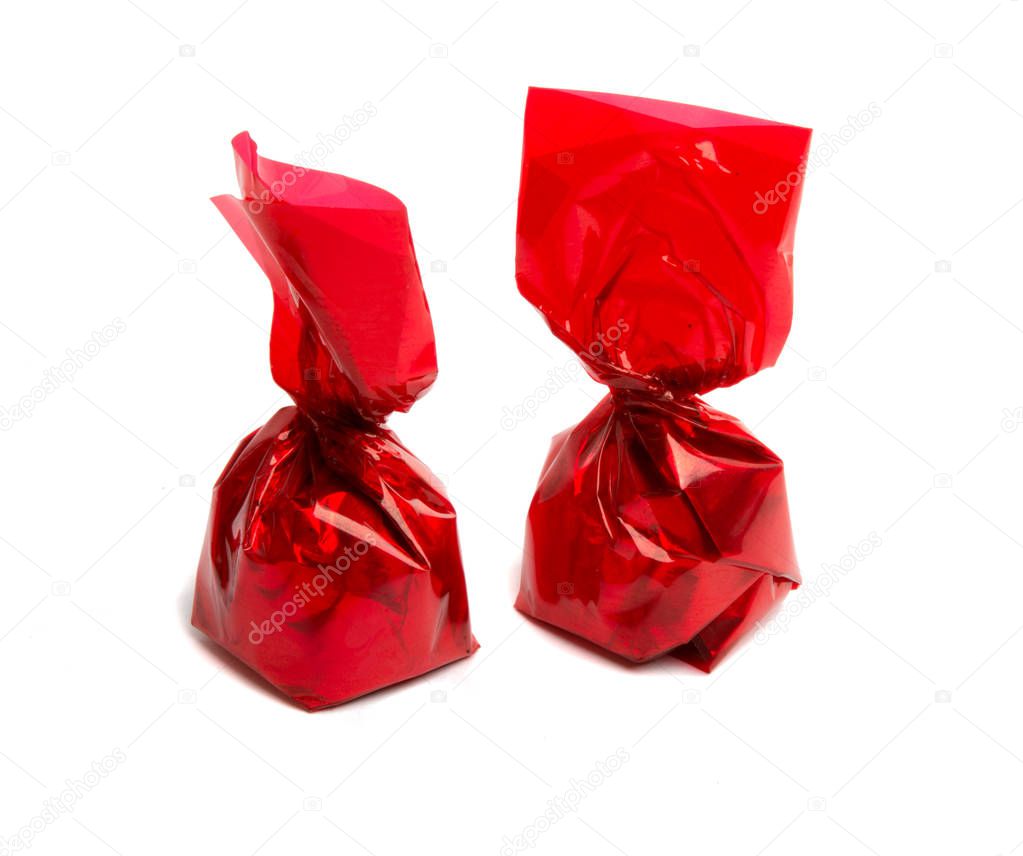 Sweets in red foil isolated