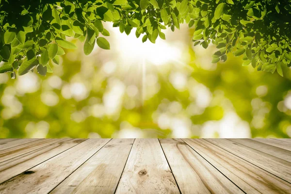 Natural wood table top on Green leaves with nature blurred in ba — Stock Photo, Image