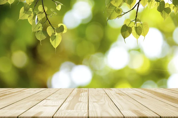 Mesa de madera vacía y hojas verdes (Bonhi) colgando — Foto de Stock