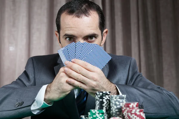 Casino worker holds cards — Stock Photo, Image