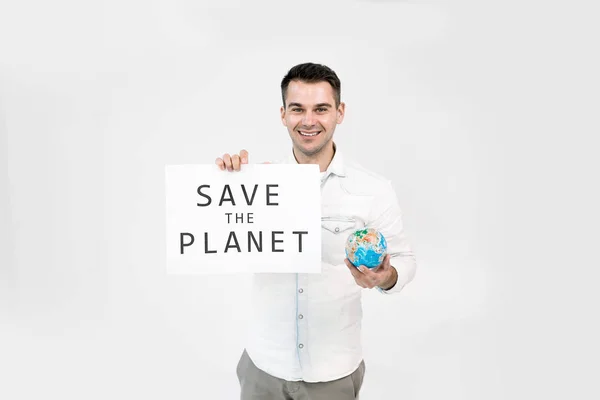 Save planet and happy Earth day. Globe in the hands of young man and paper poster with Save the planet text, isolated on white background. Save Earth concept.