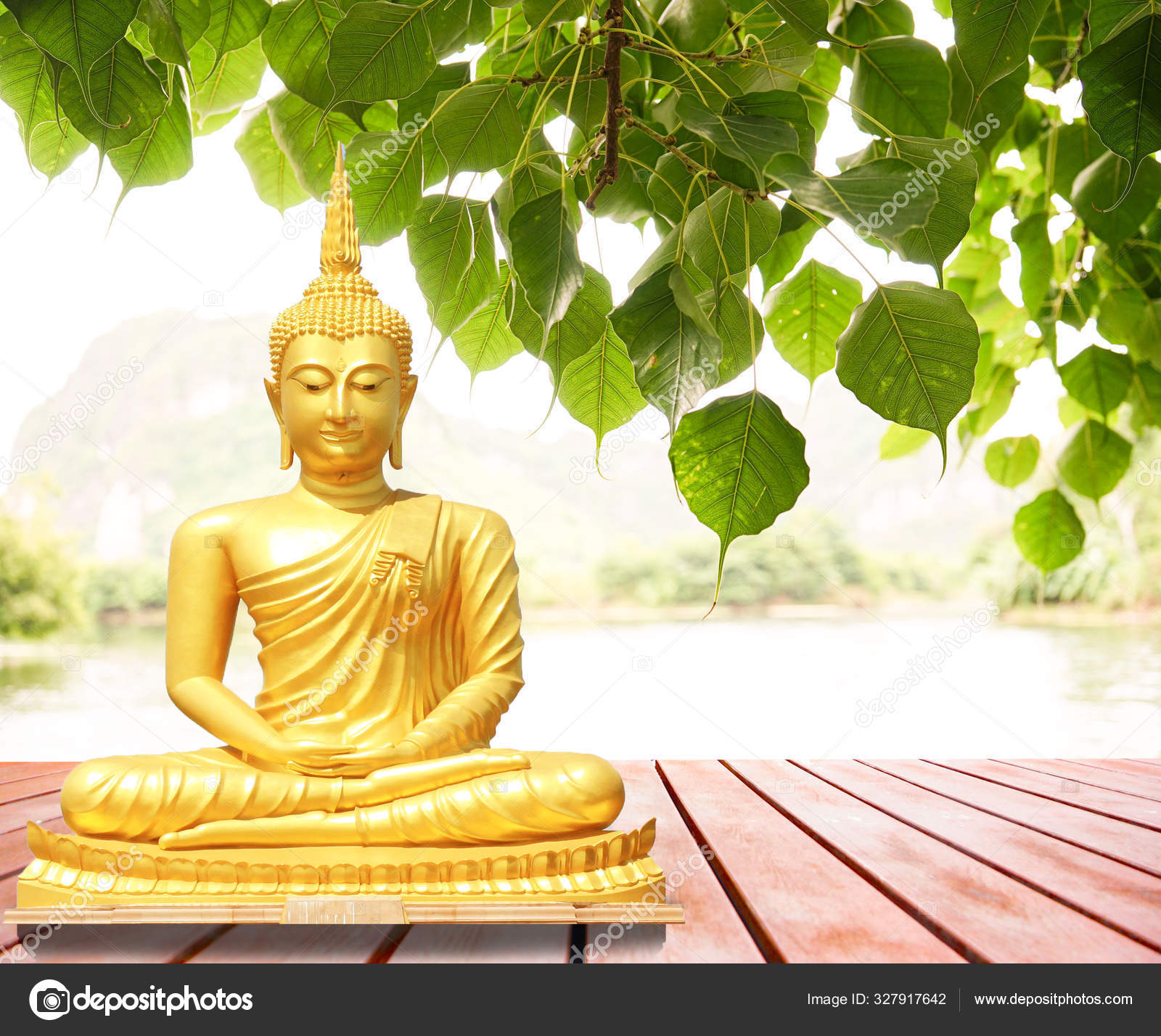 The statue of the Buddha sitting under the Bodhi tree. Stock Photo by