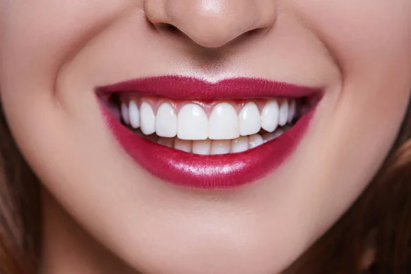 Healthy white smile close up. Beauty woman with perfect smile, lips and teeth. Beautiful Model Girl with red lips isolated on white background. with perfect skin. Teeth whitening.