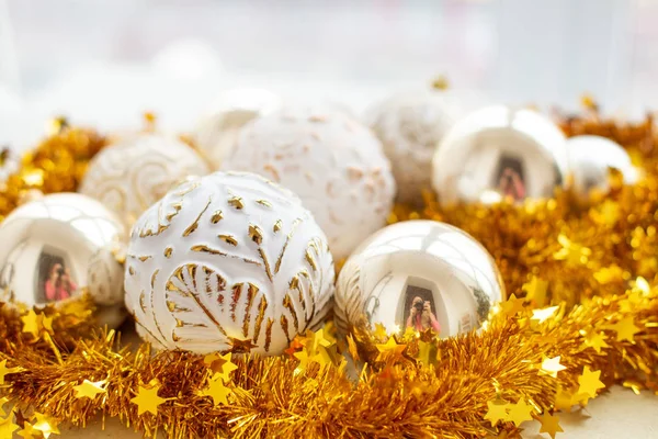 Christmas golden decoration with different bubbles and shiny garland, soft focus. Christmas composition.