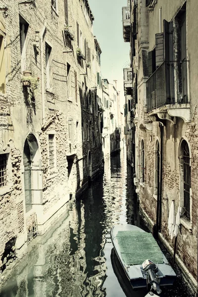 A quiet canal without any people in Venice, Italy with a vintage look.