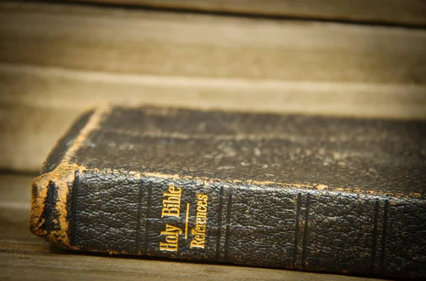 Bible Resting Its Side Wooden Table Only Spine Focus Slight — Stock Photo, Image