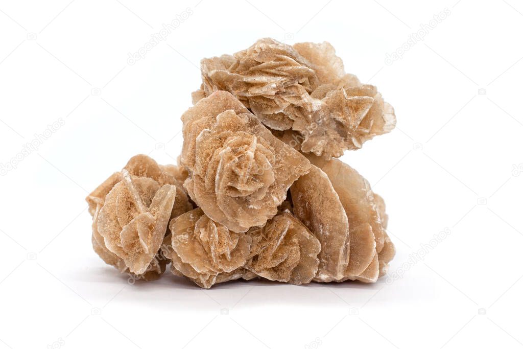 Sahara desert mineral rose isolated on white background. Sand Rose, Selenite Rose or Gypsum Rose. Unfading flower. Bizarre stones. the aggregate of gypsum crystals that are formed in a layer of sand. 