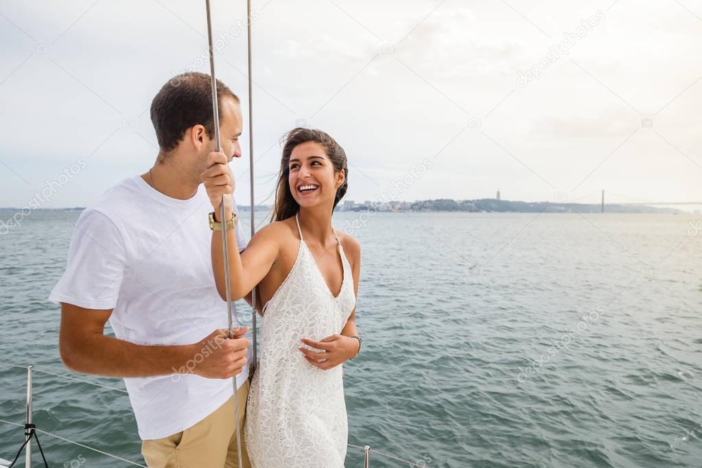 Group of friends having fun in boat in river