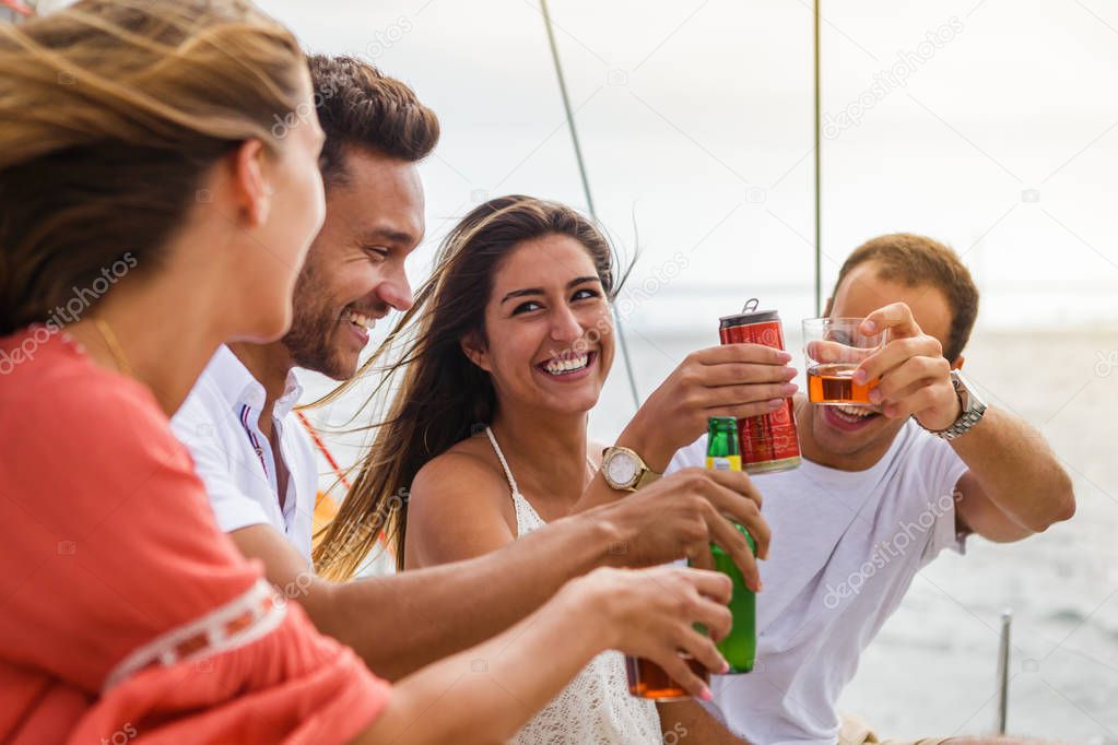 Group of friends having fun in boat in river