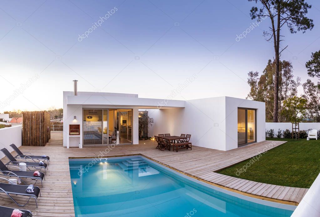 Modern house with garden swimming pool and wooden deck