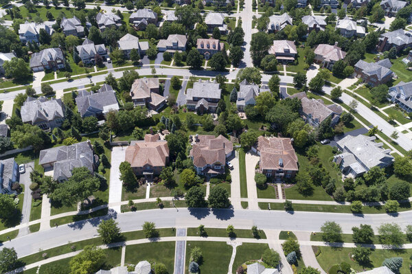 Aerial view of a tree-lined neighborhood in a Chicago suburban city in summer.