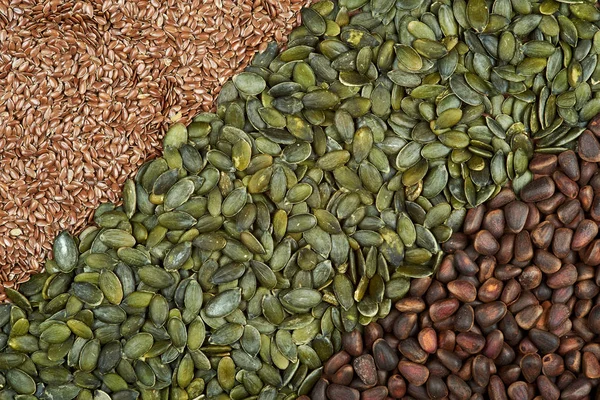 Texture di semi alternati di pinoli, semi di lino e semi di zucca . — Foto Stock