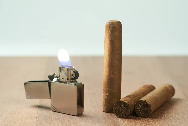Cigarrer med en brinnande bensin lättare. — Stockfoto