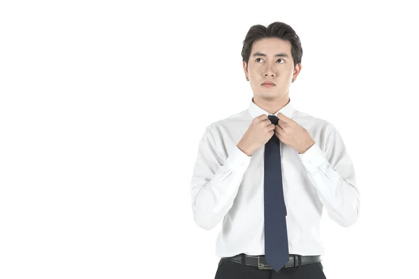 Portret van slimme jonge Aziatische zakenman aan te passen en koppelverkoop nek — Stockfoto