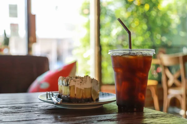 Close up of takeaway plastic cup of iced black coffee (Americano