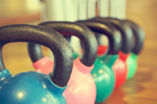 Colorful kettlebells in gym — Stock Photo, Image