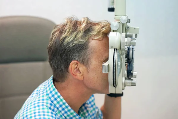 Homem verifica sua visão na máquina — Fotografia de Stock