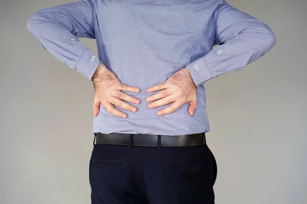 Businessman pain at lower back.