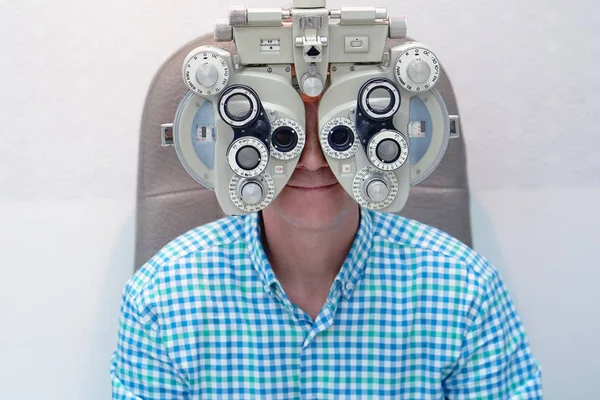 Optometrista maschio che fa test di vista per il paziente maschio in clinica — Foto Stock