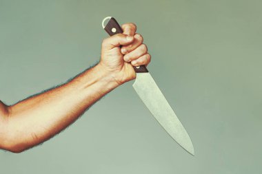 Kitchen knife in a hand. Big kitchen knife in man hand. clipart