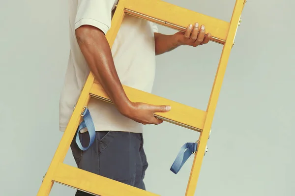 African worker with wooden ladder — Stock Photo, Image