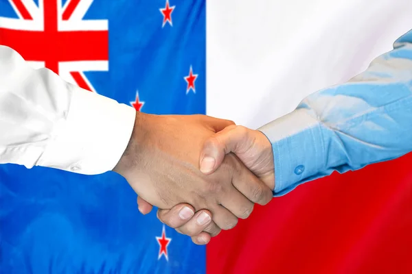 新西兰和波兰国旗背景握手. — 图库照片