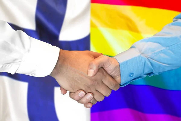 Apretón de manos en Finlandia y fondo de bandera gay LGBT . —  Fotos de Stock