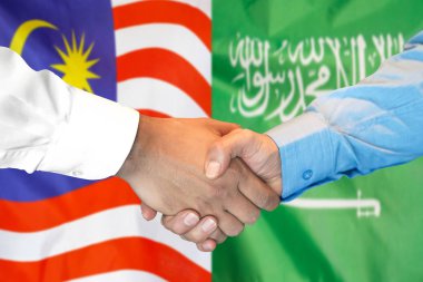Malezya ve Suudi Arabistan bayrak geçmişi üzerine el sıkışma.