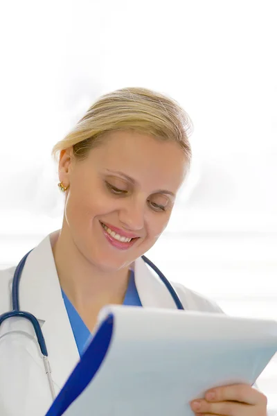 A female doctor with a folder isolated on white background.